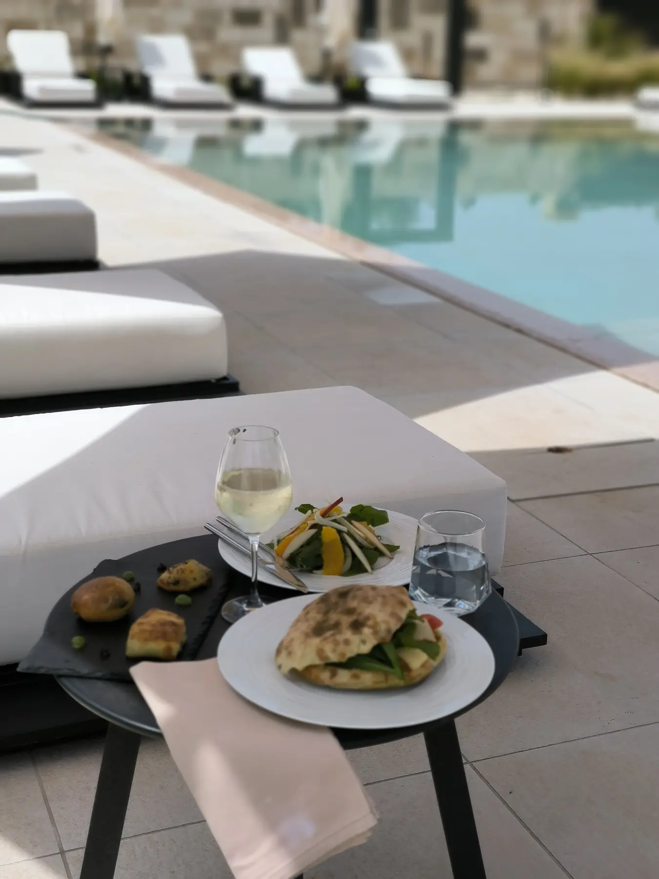 Cold dishes and local wine served by the pool at Salento Winery Lodge
